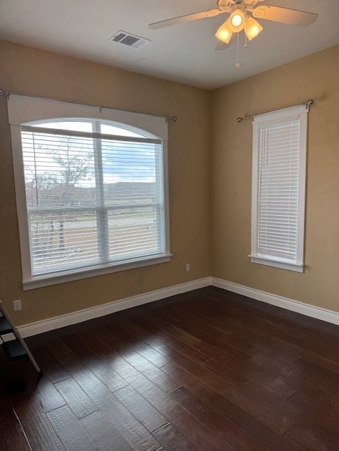 unfurnished room with dark wood-type flooring and ceiling fan