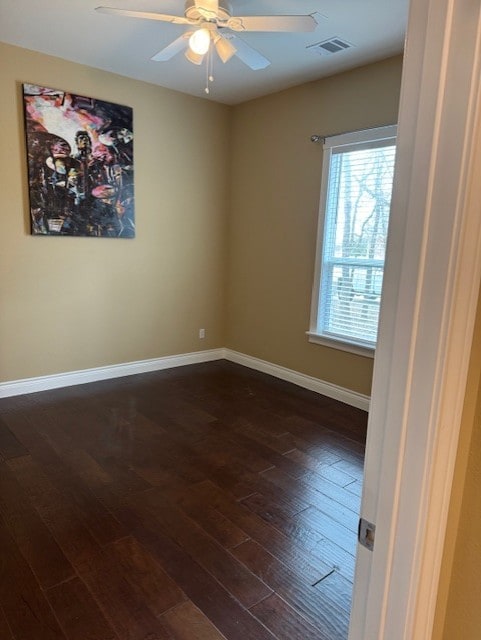 unfurnished room featuring dark hardwood / wood-style floors and ceiling fan