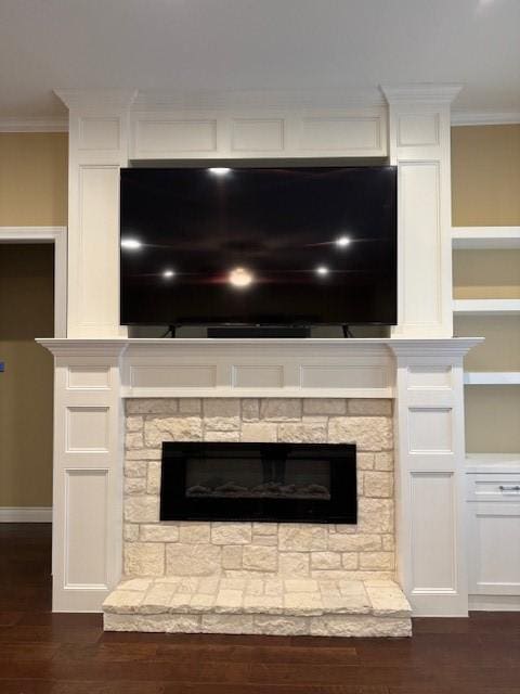 interior details featuring crown molding, wood-type flooring, and a fireplace