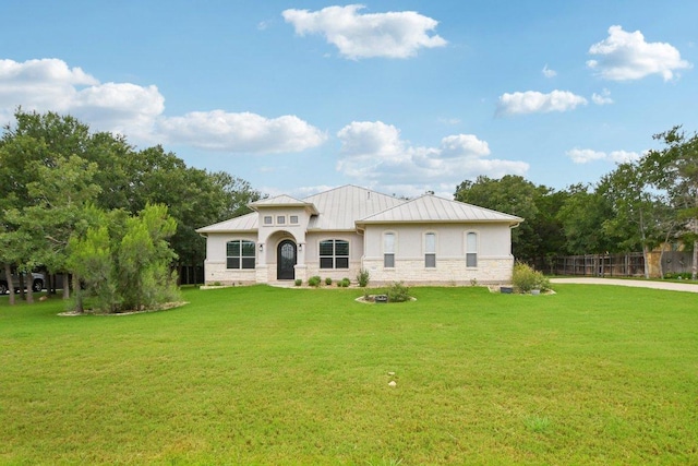 124 Abamillo Dr, Bastrop, TX 78602 - rear view of property featuring a standing seam roof, stone siding, a metal roof, and stucco siding
