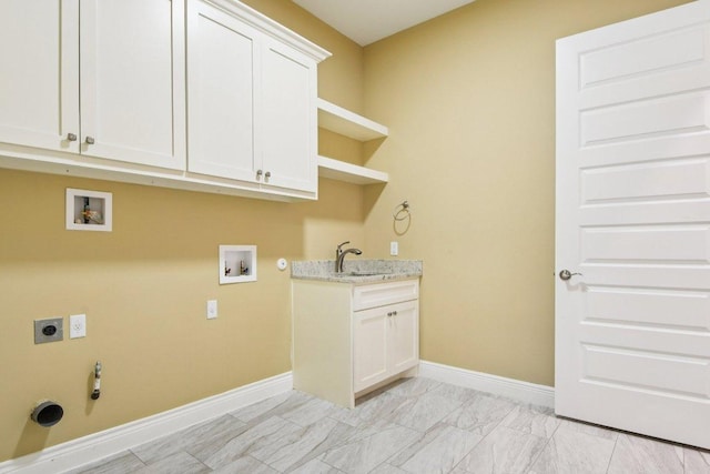 124 Abamillo Dr, Bastrop, TX 78602 - washroom with gas dryer hookup, electric dryer hookup, washer hookup, cabinet space, and light marble finish floors