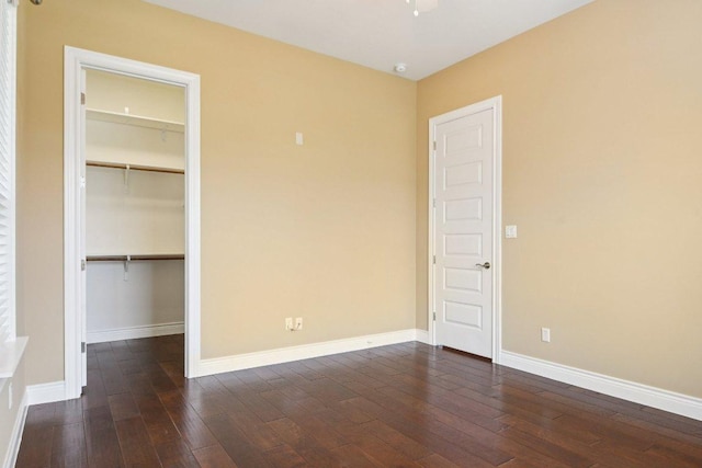 124 Abamillo Dr, Bastrop, TX 78602 - unfurnished bedroom with a walk in closet, dark wood-style floors, and a closet