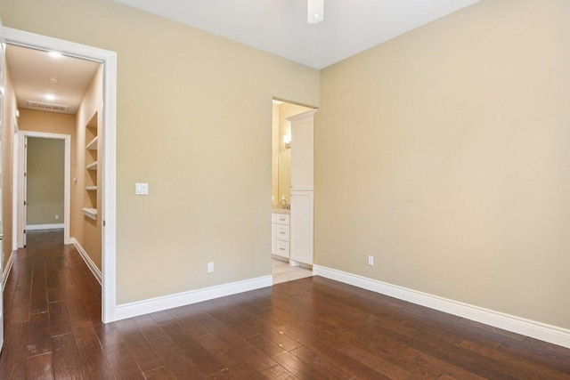 124 Abamillo Dr, Bastrop, TX 78602 - unfurnished room featuring dark wood finished floors and built in shelves