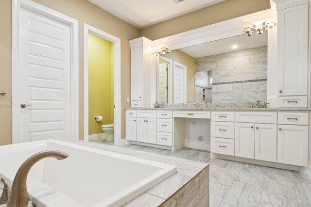 124 Abamillo Dr, Bastrop, TX 78602 - full bathroom with double vanity, a bathtub, and marble look tile flooring