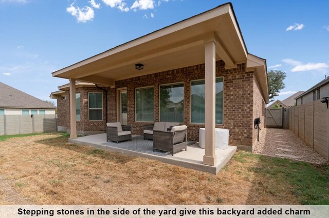 rear view of property featuring a yard and a patio