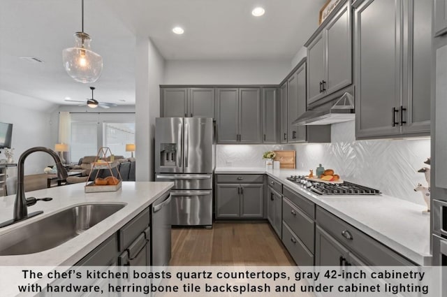 kitchen with sink, gray cabinets, appliances with stainless steel finishes, backsplash, and decorative light fixtures