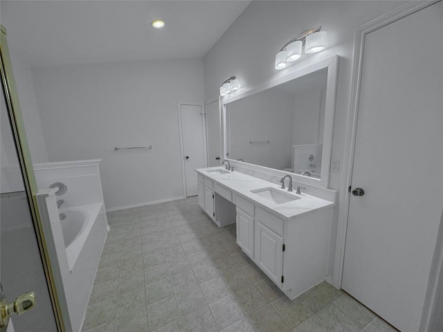 bathroom with vanity, tile patterned floors, and a tub to relax in