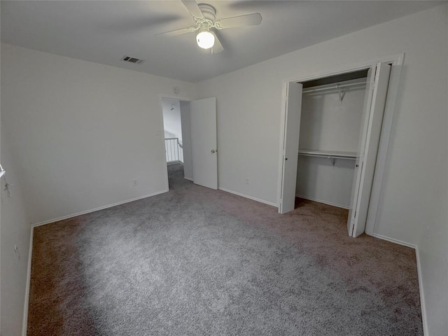 unfurnished bedroom with carpet floors, ceiling fan, and a closet