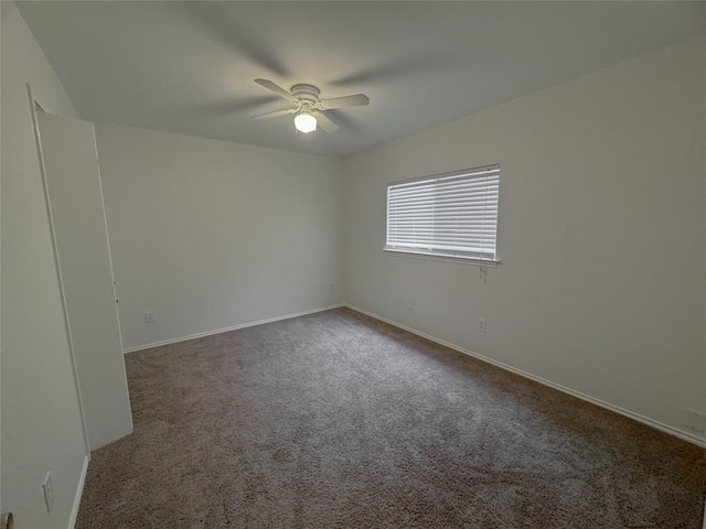 carpeted spare room featuring ceiling fan