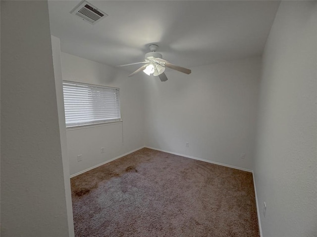 unfurnished room with ceiling fan and carpet