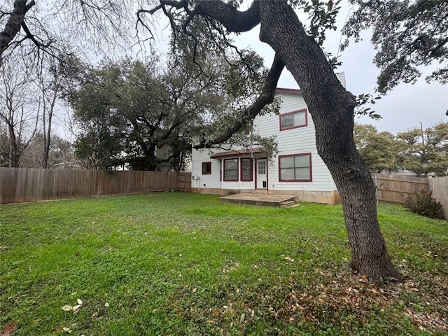 rear view of property with a patio area and a lawn