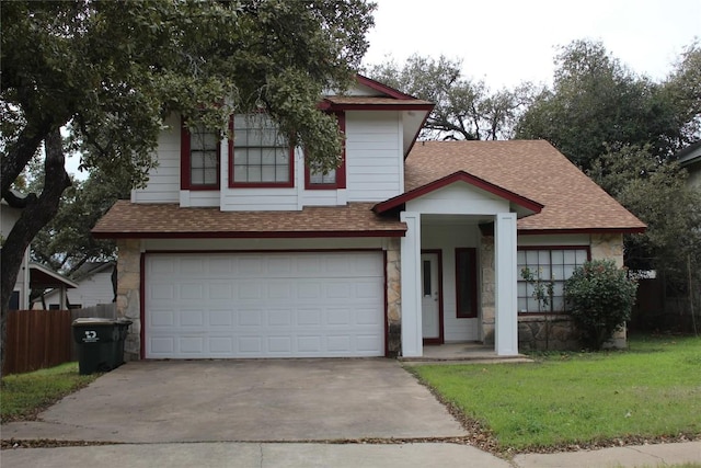 view of front of home with a garage and a front lawn