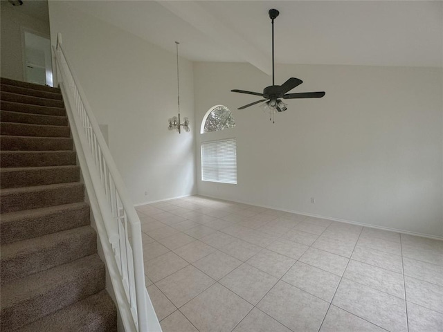 interior space featuring beam ceiling, light tile patterned flooring, ceiling fan with notable chandelier, and high vaulted ceiling