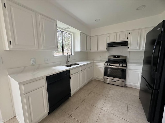 kitchen with light tile patterned flooring, white cabinets, sink, and black appliances