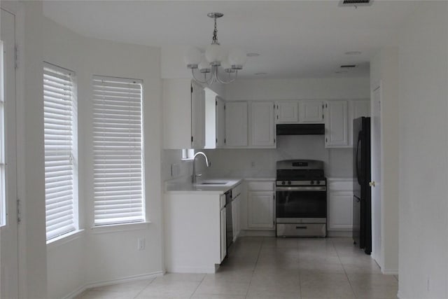 kitchen featuring sink, stainless steel appliances, white cabinets, light tile patterned flooring, and decorative light fixtures