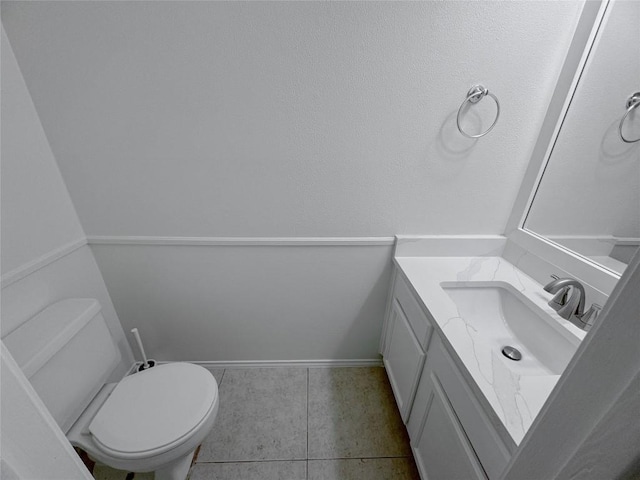 bathroom with tile patterned flooring, vanity, and toilet