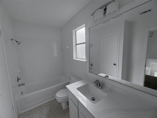 full bathroom with tiled shower / bath, vanity, and toilet