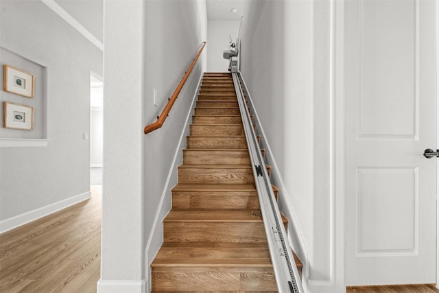 stairs featuring baseboards and wood finished floors