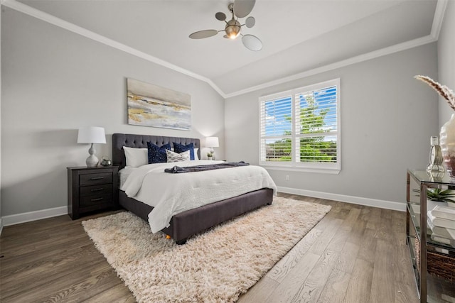 bedroom featuring crown molding, wood finished floors, and baseboards