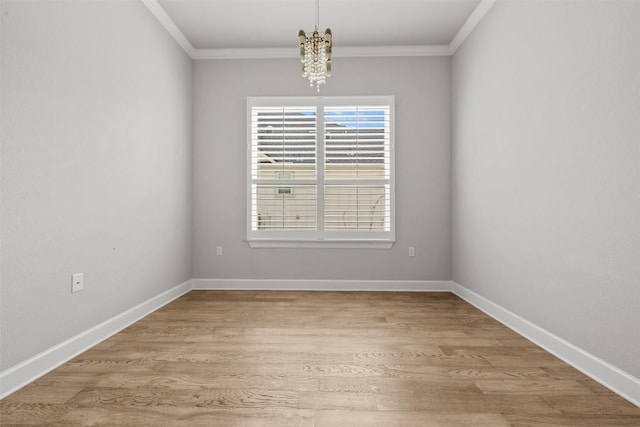 unfurnished room featuring ornamental molding, baseboards, and light wood-style flooring