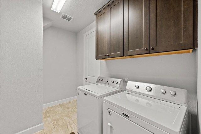 laundry room featuring cabinet space, separate washer and dryer, a textured ceiling, visible vents, and baseboards