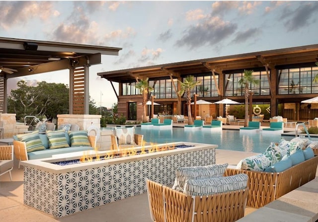 pool with outdoor lounge area and a patio area