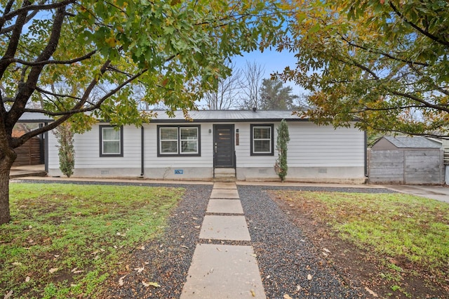 ranch-style house with a garage and a front lawn