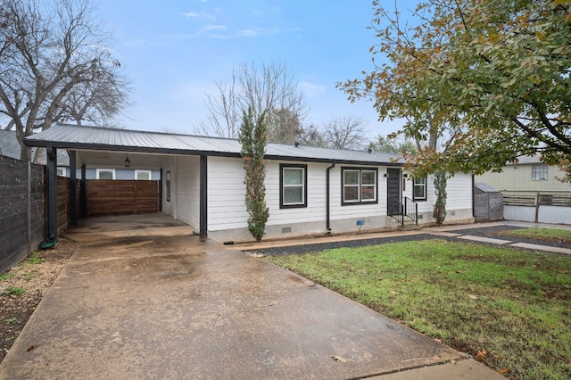 single story home with a front lawn and a carport