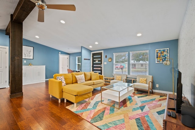 living room with hardwood / wood-style flooring, ceiling fan, and lofted ceiling