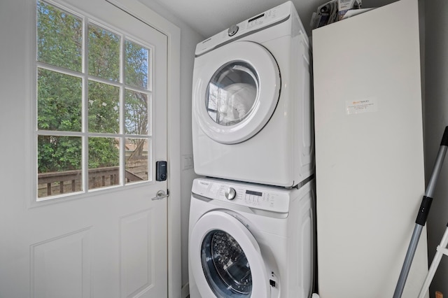 clothes washing area with stacked washer / drying machine