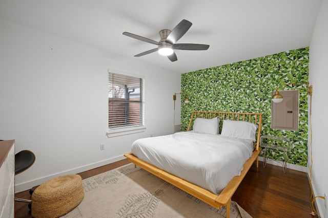 bedroom featuring wood-type flooring, electric panel, and ceiling fan