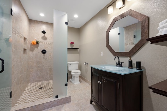 bathroom featuring vanity, an enclosed shower, and toilet