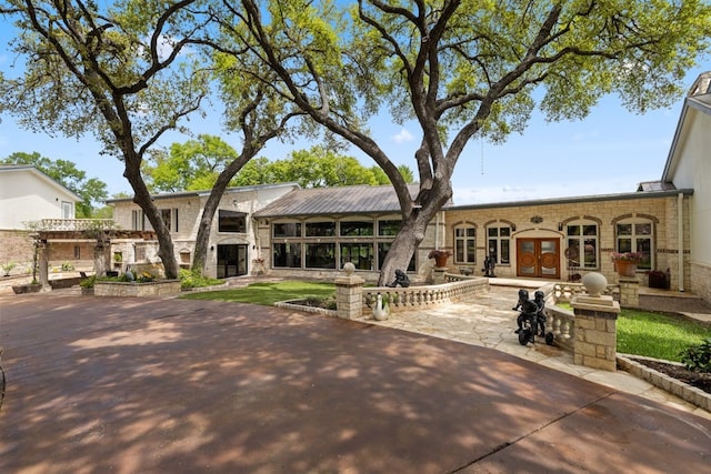 back of house featuring a patio and french doors