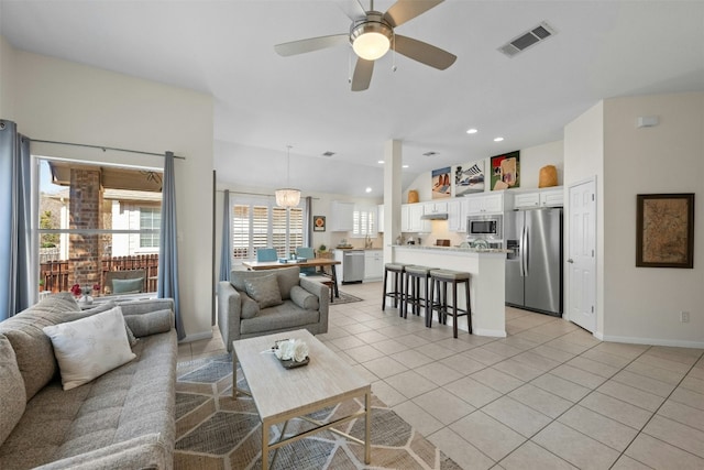 living room with light tile patterned floors and ceiling fan