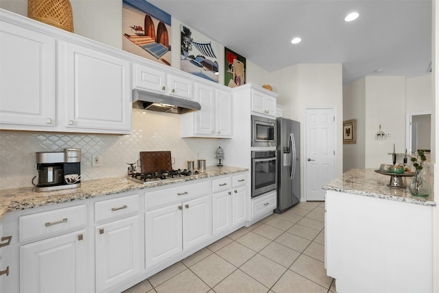 kitchen featuring tasteful backsplash, light tile patterned flooring, appliances with stainless steel finishes, and white cabinets