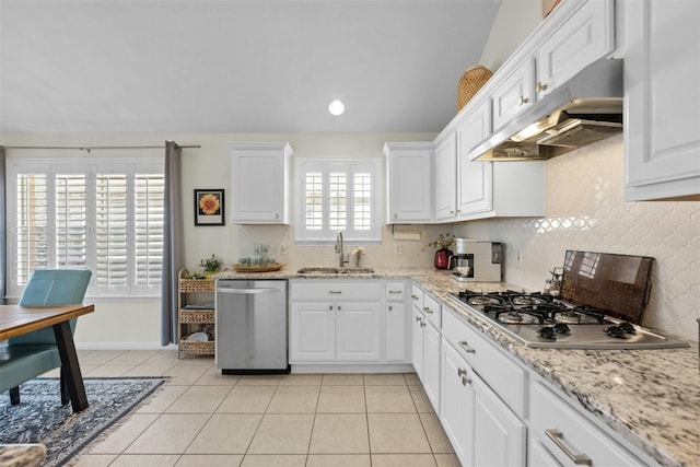 kitchen with sink, light tile patterned floors, white cabinetry, stainless steel appliances, and tasteful backsplash