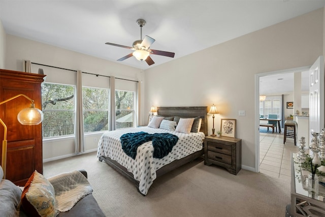 carpeted bedroom featuring ceiling fan and multiple windows