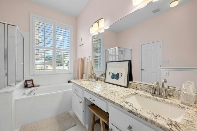 bathroom featuring vanity and shower with separate bathtub