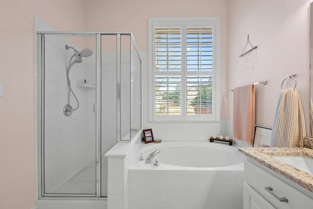 bathroom with vanity and independent shower and bath