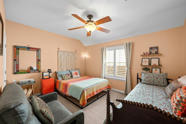 carpeted bedroom with vaulted ceiling and ceiling fan