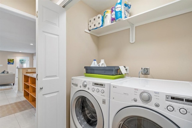 laundry room with separate washer and dryer and light tile patterned floors