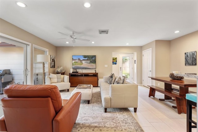 tiled living room featuring ceiling fan