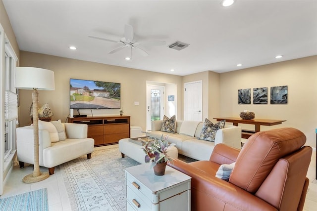 tiled living room featuring ceiling fan