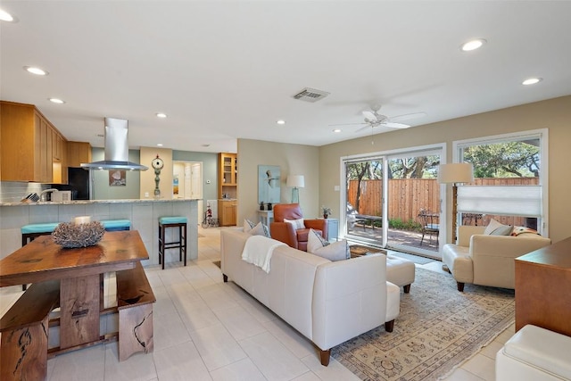 living room with light tile patterned floors and ceiling fan