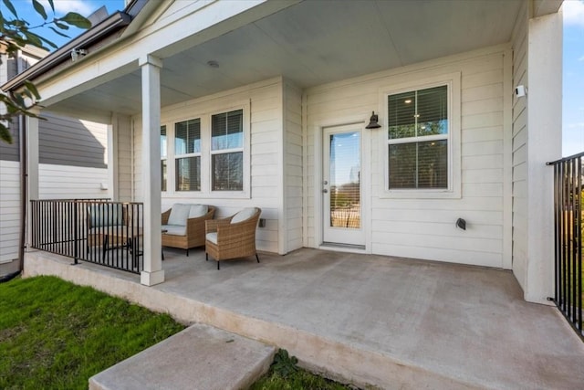 doorway to property with an outdoor living space, a patio, and a porch