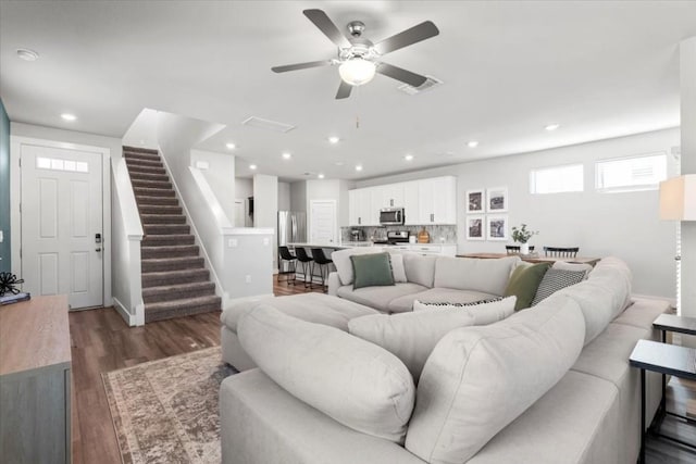 living room with dark hardwood / wood-style floors and ceiling fan