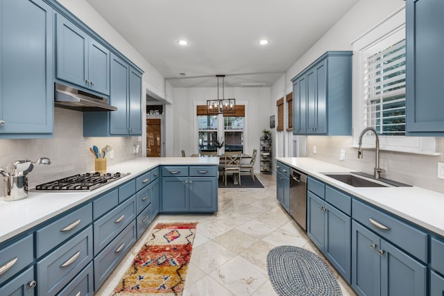 kitchen featuring hanging light fixtures, appliances with stainless steel finishes, sink, and blue cabinetry