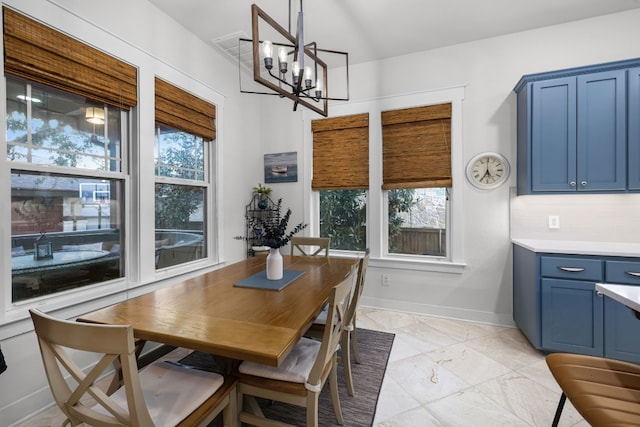 dining space featuring plenty of natural light and a chandelier