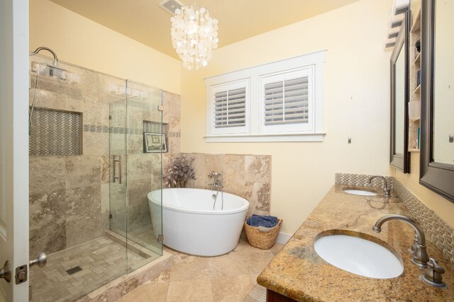 bathroom with vanity, a chandelier, and separate shower and tub