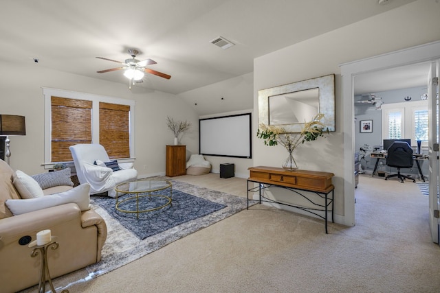 living room featuring light carpet, vaulted ceiling, and ceiling fan